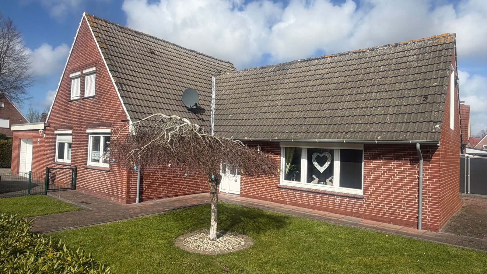 Ferienhaus Moi Stuuv in Norden, Ansicht mit Rasen und Hauseingang
